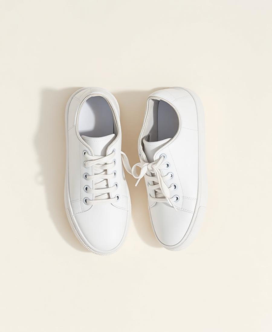 A pair of clean white leather sneakers